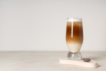 Glass of iced latte on white background