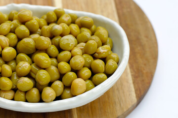 Canned green peas on white background.