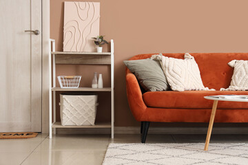Interior of stylish living room with brown sofa and coffee table near beige wall