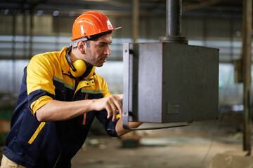 engineer or technician checking lathe machine in the factory
