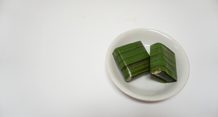 Lemper, a traditional snack from Indonesia, made from sticky rice, steamed with coconut milk,...