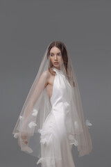  A woman in a wedding dress is holding a bouquet of flowers. Concept modern wedding dress for the bride.