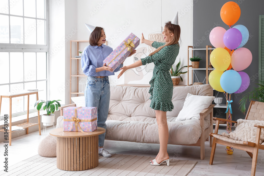 Poster Young woman giving her friend gift at Birthday party