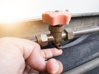 Checking for refrigerant gas leaks in outdoor HVAC systems. check oil leaks on cut off valve.