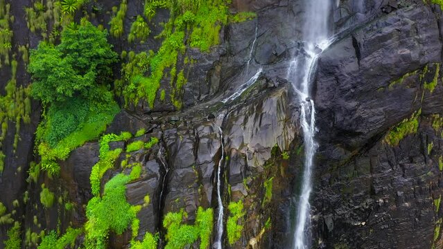 Top view of beautiful waterfall in the mountains among the jungle. Diyaluma Falls, Sri Lanka.