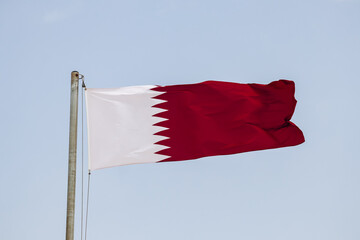 Waving flag of Qatar, in Doha