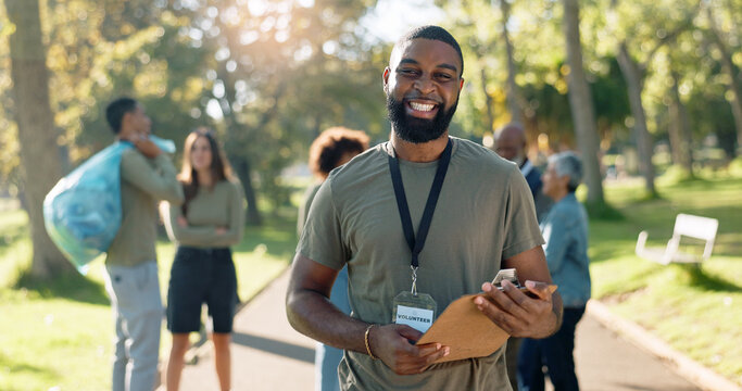 Man, volunteer and smile portrait with clipboard in nature, checklist and environment sustainability project with group. Recycle, waste management and cleaning outside trash, help and ngo support