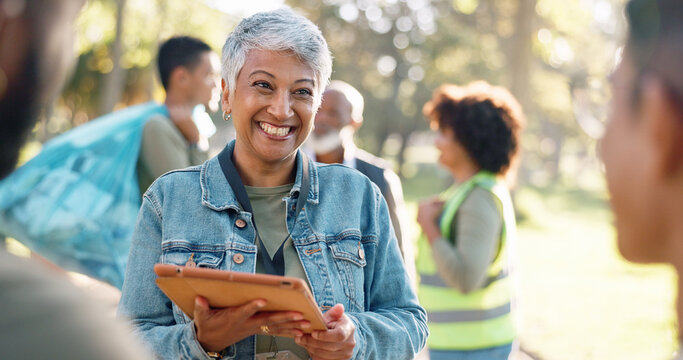 Park, woman and smile planning with tablet for volunteers, community project or nature sustainability. Humanitarian, recycling or senior leader in charity service or NGO for pollution cleanup