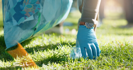 Hand, person and volunteer with pick up dirt at park with plastic for cleaning, care and community...