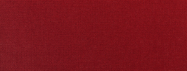 Dark red background from textile material with wicker pattern and texture, macro. Structure of wine...