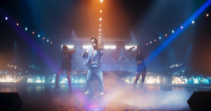 Futuristic Music Concert Concept in Metaverse. Real Pop Music Artist Performing on Stage in Front of a Massive Crowd of Digital Avatars From the Internet, 3D Cyber Personas From an Online Video Game