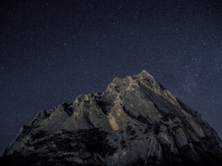 Rock under scarry sky at night astrophotography