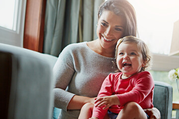 Mom, toddler and happy with laughing on sofa in home living room with care, love and bonding...