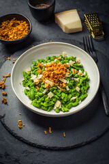 German egg noodles - Spinach spaetzle with parmesan and roasted onions