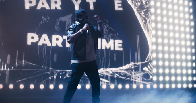 Young African Hip Hop Musician Delivers an Unforgettable Concert. Black Rapper Dancing in Smoke on Stage, Charismatic Presence and Gangster Lyrics Captivate and Excite the Crowd of Music Goers