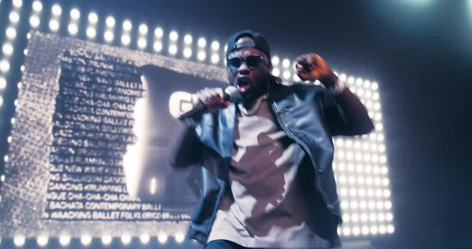 Fans Experiencing a Powerful Musical Performance by a Talented African Hip Hop Artist. Singer Works on Stage With a Blend of Emotion and Energy. Light Show Animation on Big Screen in the Background