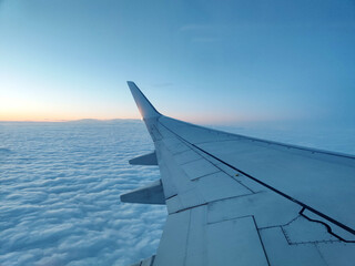 clouds and wing of the airplane seen from the window