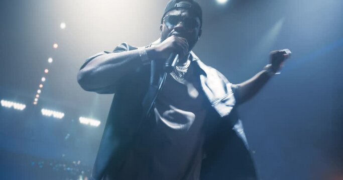 Fans Experiencing a Powerful Musical Performance by a Talented African Hip Hop Artist. Portrait of a Singer Working on Stage With a Blend of Emotion and Energy. Light Show Illuminate the Performer