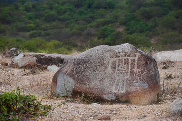 Carved rocks with ancient petroglyphs created by a past culture, a testament to early human artistry and symbolism.