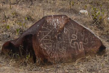 Carved rocks with ancient petroglyphs created by a past culture, a testament to early human artistry and symbolism.