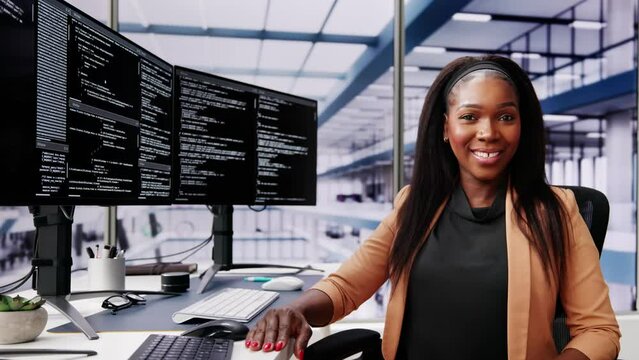 African American Coder Using Computer At Desk