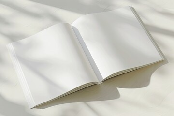 an open white book casts a shadow on the ground