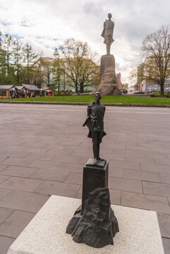 Nizhny Novgorod, Russia - May 11, 2024: The miniature bronze copy of the monument to Maxim Gorky against the background of the original on Maxim Gorky Square.