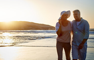 Mature, happy couple and hug with beach sunset for love, support or embrace together in nature....
