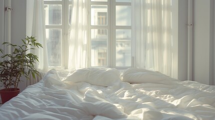 White bed sheets with sunlight streaming through window.
