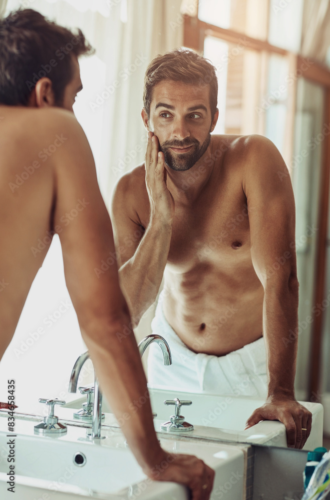 Canvas Prints Beauty, face and beard care with man looking in bathroom mirror during morning routine at home. Skin, health and reflection for guy, grooming and wellness for natural and facial treatment results