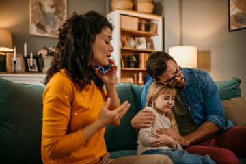 Worried mother call ambulance doctor, father hugging and take care of sick small child