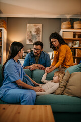 Obraz premium Young doctor checking and taking care of little girl during a home visit