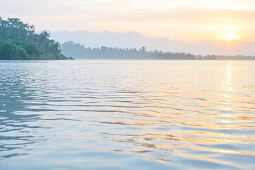 Calm water with reflection of golden sunset