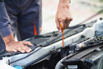 car service center mechanics are checking condition car and engine make sure they are ready use and in perfect condition according center warranty. periodic vehicle inspections for safety in driving.