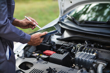 car service center mechanics are checking condition car and engine make sure they are ready use and in perfect condition according center warranty. periodic vehicle inspections for safety in driving.
