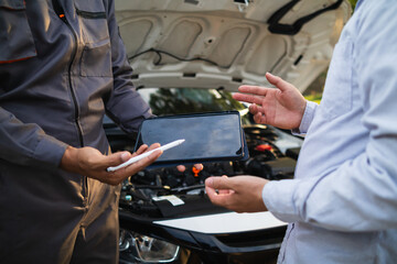 car service center mechanics are checking condition car and engine make sure they are ready use and in perfect condition according center warranty. periodic vehicle inspections for safety in driving.