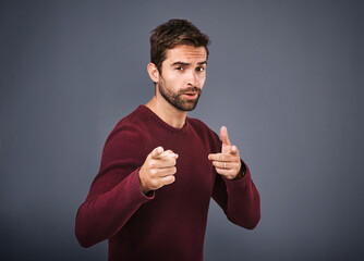 Studio, pointing and portrait of man, proud and choice for fashion, gesture and jersey for winter....