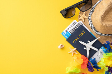 Top view of summer travel essentials including a passport, boarding pass, sunglasses, and hat on a bright yellow background