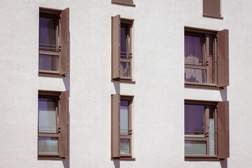 Obraz premium Window Shutters Outdoor. Modern Sliding Metal Shutters Blinds on Large Windows of Apartment Building. Safety Window concept. 