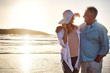 Senior, happy couple and hug with beach sunset for love, embrace or bonding together in nature....