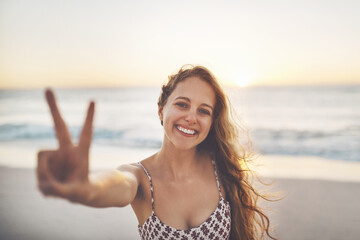 Woman, portrait and peace sign at beach with smile, relax and outdoor with v emoji, review and...