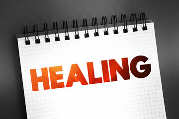 Healing - process of becoming well again, after a cut or other injury, text on notepad concept for...