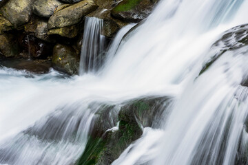 Obraz premium The stones under the waterfall, close-up waterfall as a background.