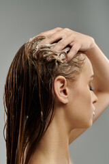 Alluring woman applying hair care product and washing hair.