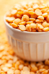 Uncooked, yellow peas in bowl. Split peas grains