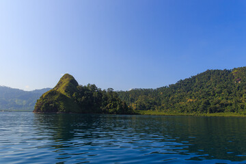 Serene Tropical Escape: Lush Green Islands Rising from Tranquil Blue Waters Under a Clear Sky ; ocean at padang, west sumatra ; indonesia tourism
