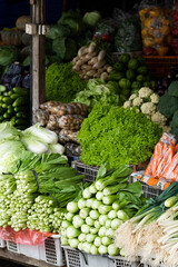 Beautifully arranged fresh vegetables at a traditional market, for sale.