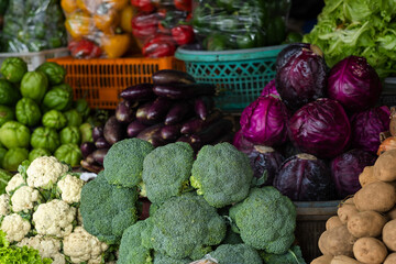 Beautifully arranged fresh vegetables at a traditional market, for sale.