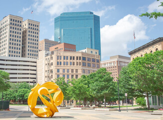 June 6, 2020: Downtown buildings and trees of the Fort Worth Texas city skyline. Photo taken in Fort Worth Texas on a partly cloudy day