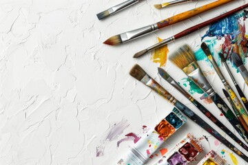 Fototapeta premium Flat lay with a used artistic tools and place for text on a white background. AI generative
